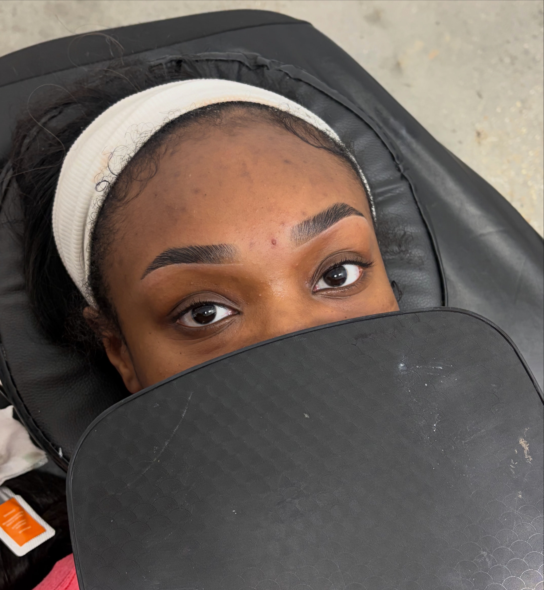 Brow sculpt before and after — dark skin client — after